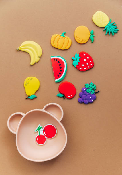 istock Bright silicone dishware on light background. Serving baby, first feeding concept. Flat lay, copy space, top view 1304605338