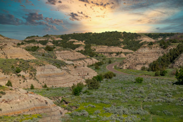 Sunset over the North Dakota Badlands Dramatic sky over the land. Rock formations Extreme terrain. ￼ north dakota stock pictures, royalty-free photos & images