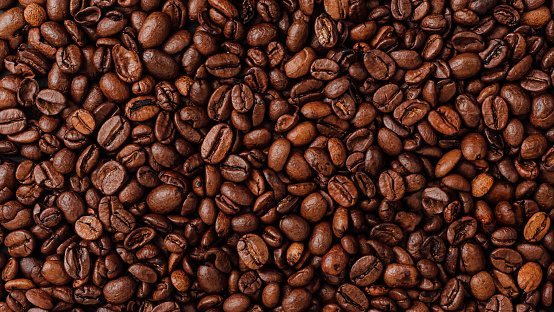 Roasted coffee beans background texture. Overhead view