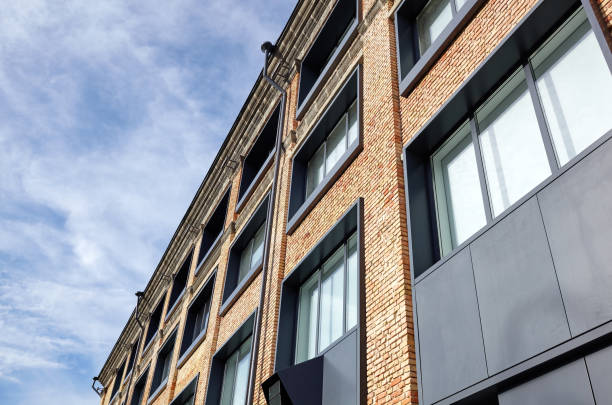istock Brick building with windows and downspout against blue sky 1304608882