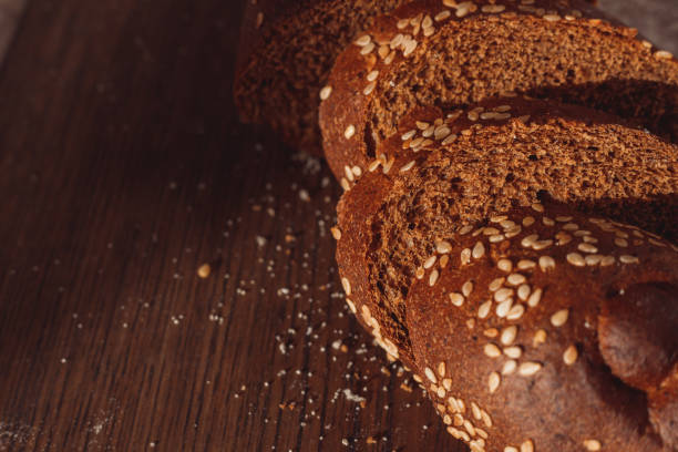 istock Sliced rye bread on cutting board. Whole grain rye bread with seeds 1304609176