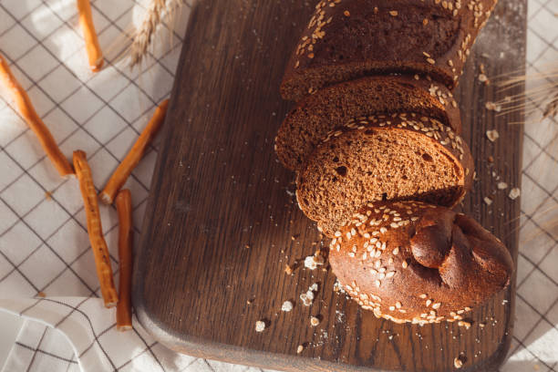 istock Sliced rye bread on cutting board. Whole grain rye bread with seeds 1304609187