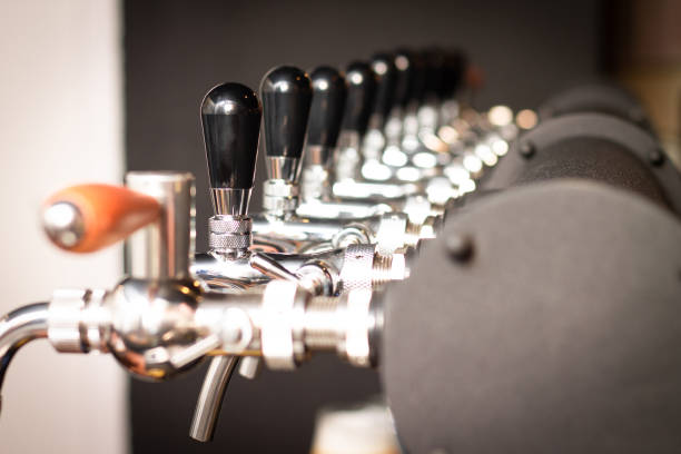 istock Partially blurred silvery bar beer taps in pub 1304609929