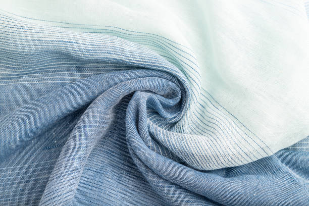 istock Fragment of blue linen tissue. Top view, natural textile background and texture. wave concept, abstract, spiral. 1304610830