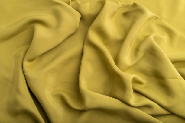 istock Fragment of green olive silk tissue. Top view, natural textile background and texture. wave concept, abstract. 1304610842