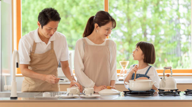 istock young japanese family cooking in kitchen 1304611883