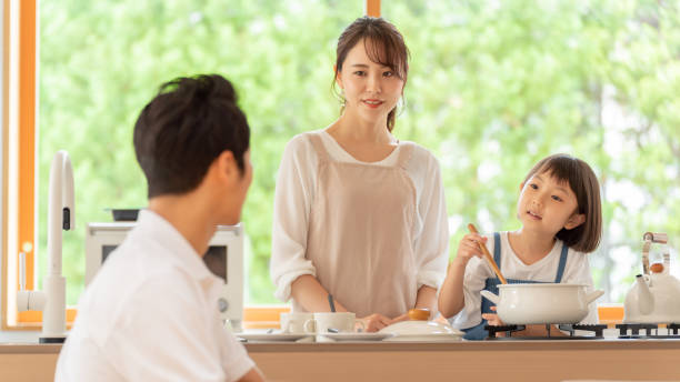 istock young japanese family cooking in kitchen 1304611884