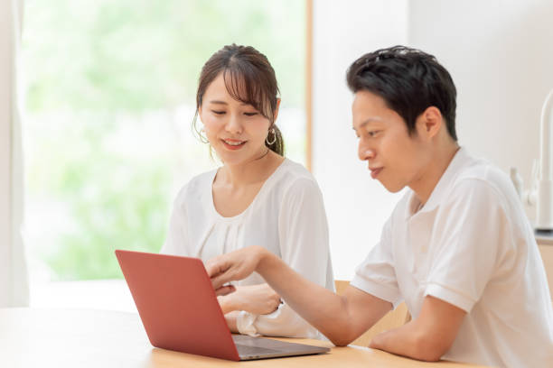 istock young japanese couple using laptop in the kitchen 1304611946