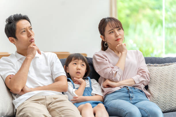 young japanese family relaxing on the sofa