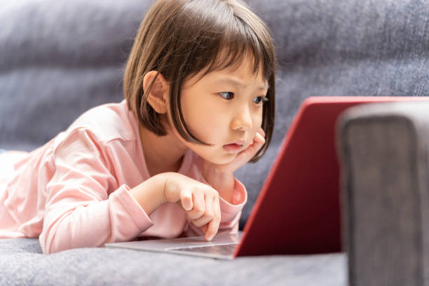 istock young japanese girl using laptop on the sofa 1304612016