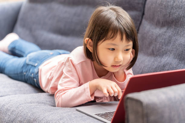 istock young japanese girl using laptop on the sofa 1304612048
