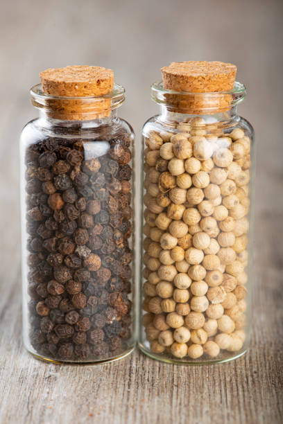 istock Two glass jars with black and whit pepper 1304613014