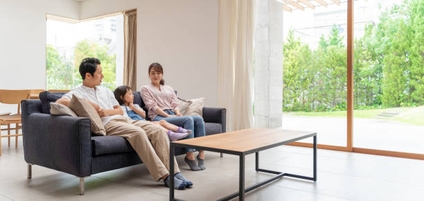 istock young japanese family relaxing on the sofa 1304614902
