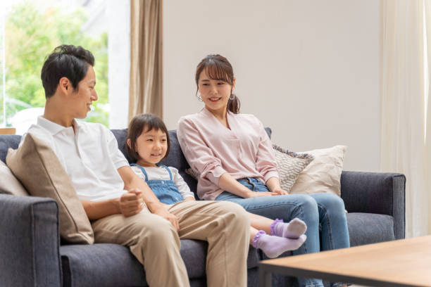 istock young japanese family relaxing on the sofa 1304614903