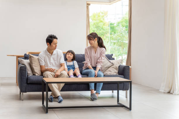 istock young japanese family relaxing on the sofa 1304614905