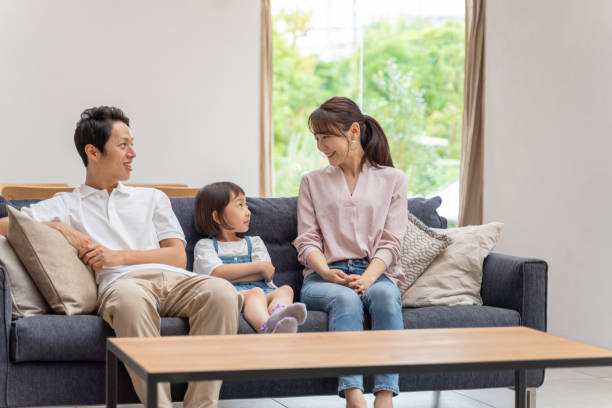istock young japanese family relaxing on the sofa 1304614911