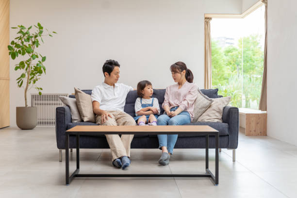 istock young japanese family relaxing on the sofa 1304614915