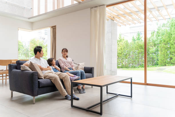 istock young japanese family relaxing on the sofa 1304614916