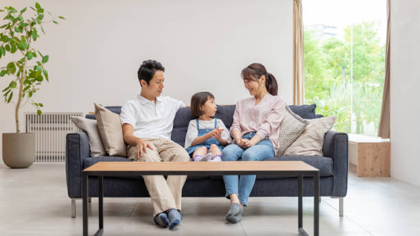 istock young japanese family relaxing on the sofa 1304614917