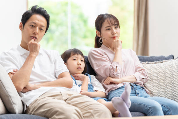 istock young japanese family thinking on the sofa 1304614935