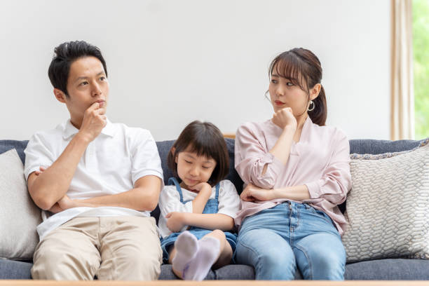 istock young japanese family thinking on the sofa 1304614936