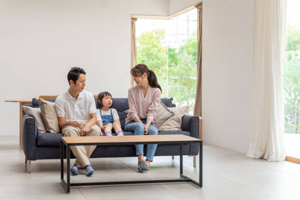 istock young japanese family relaxing on the sofa 1304614942