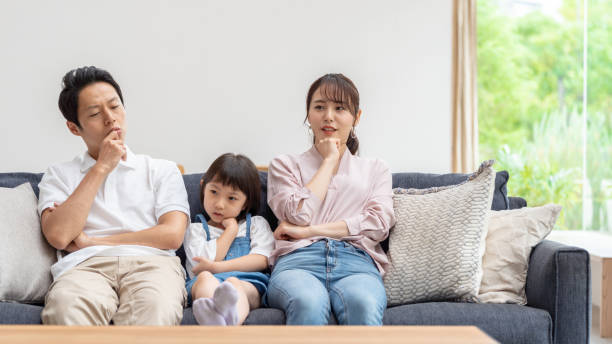 istock young japanese family thinking on the sofa 1304614952
