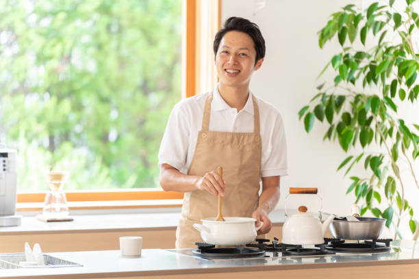 istock young japanese man cooking in kitchen 1304615006