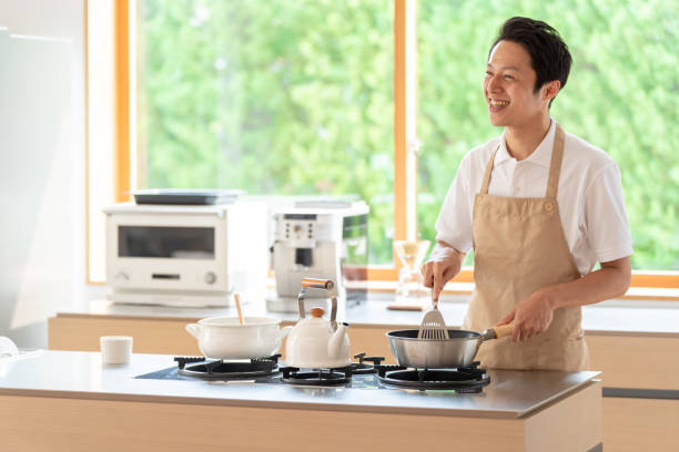 istock young japanese man cooking in kitchen 1304615009