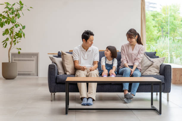 istock young japanese family relaxing on the sofa 1304615029