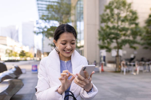istock Young businesswoman using smartphone in city 1304615656