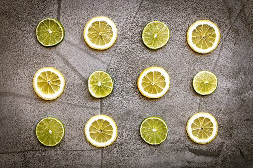 Slices of lime on cutting table, prepared for healthy meal