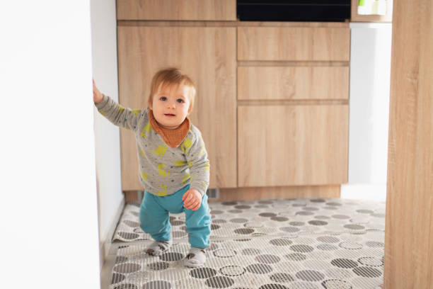 istock Adorable baby boy making his first steps at home 1304619160