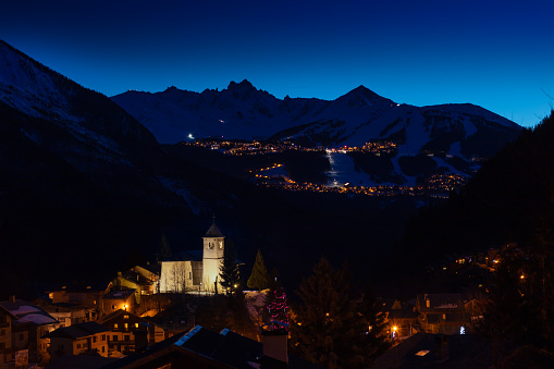 Night panorama of Champagny-en-Vanoise over Courchevel valley and ski resort with Alps mountain peaks view from