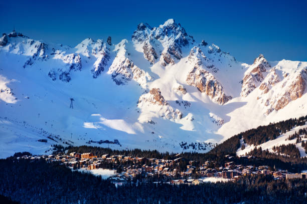 Valley of Courchevel with mountain peaks in sun Panorama of Courchevel valley and ski resort with Alps mountain peaks view from Champagny-en-Vanoise courchevel stock pictures, royalty-free photos & images