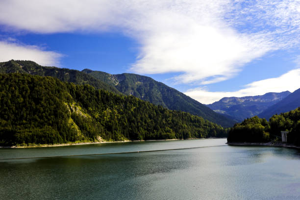 The dam is 44 m high and its crest is 180 m long. The dam impounds not only the Isar River but also its tributaries Dürrach (southern arm) and Walchen (eastern arm). The Isar and Dürrach carry large quantities of sediment and sedimentary rocks that will fill the reservoir over the next decades. For the wild river Isar, the vista del embalse de sylvenstein en el alto baviero isarwinkel (sylvensteinstausee, sylvensteinsee), que represa el río isar. el embalse fue creado, entre otras cosas, para la protección contra inundaciones. iarwinkel, valle de isar, otoño, lenggries, b