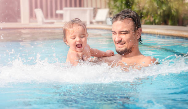 istock Father with child in the pool. 1304621669