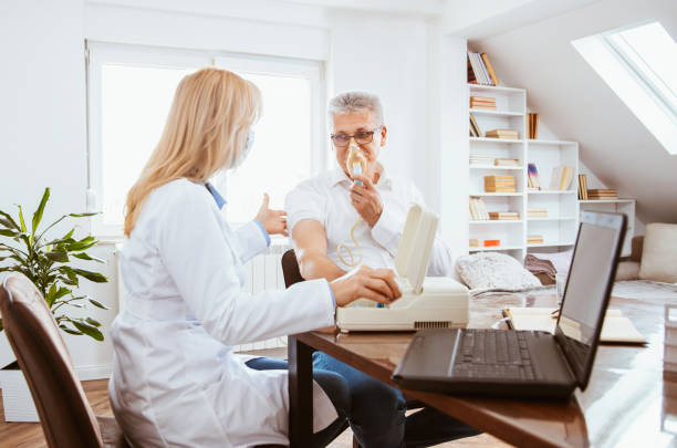 istock Inhalation treatment on a senior man in doctor's office. 1304622706