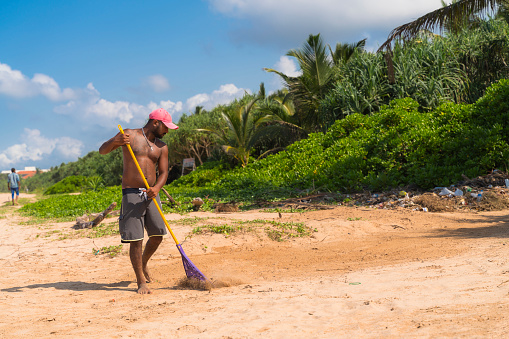 A young Sri Lankan man is working on a public beach in Aluthgama, Sri Lanka.