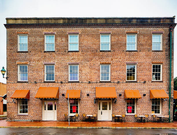 Small colonial apartment and office building with red awnings
