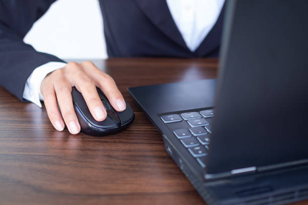 istock Selective focus Hand using mouse computer laptop. staff business woman working in office. she internet network and social media. technology concept. 1304636324