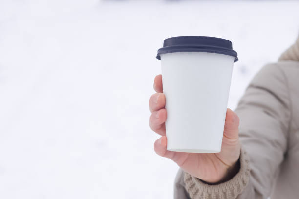 istock Coffee to go. A paper cup in a hand with an empty space for the logo. 1304643147
