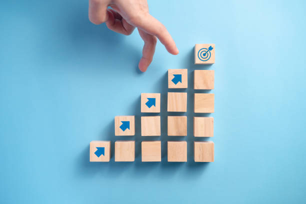 istock Businessman's hand arranging wooden blocks. 1304646542
