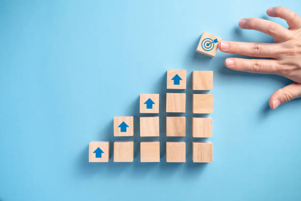 istock Businessman's hand arranging wooden blocks. 1304646562
