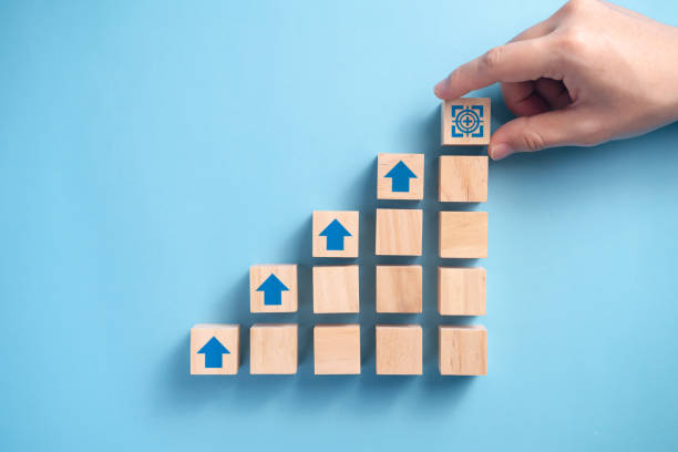 istock Businessman's hand arranging wooden blocks. 1304646565