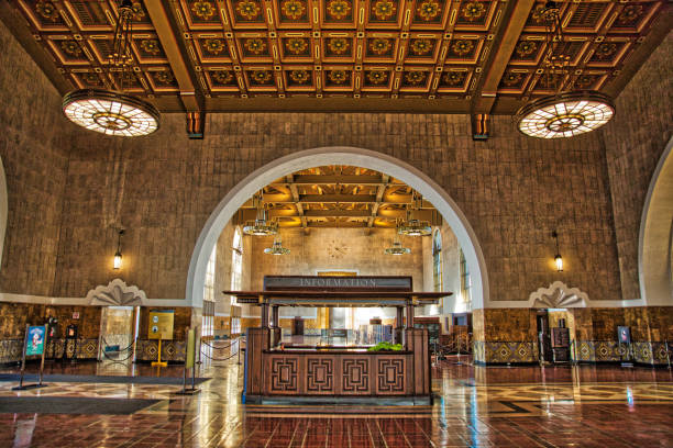 Passengers in the waiting room of Union station - the main transportation hub in Los Angeles. Designed by Parkinson & Parkinson (1939) who were responsible for City Hall and other local landmark, It combines Dutch Colonial, Mission Revival, and Streamline Moderne styles. It is in the national register of historic places (1980).