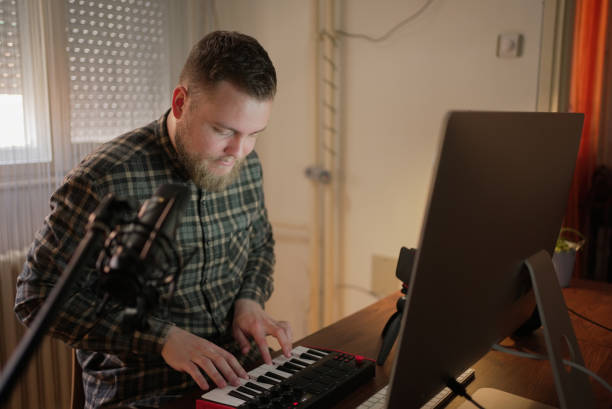 istock Musician using sound mixer while working on some new project from his home office during COVID-19 pandemic 1304650944