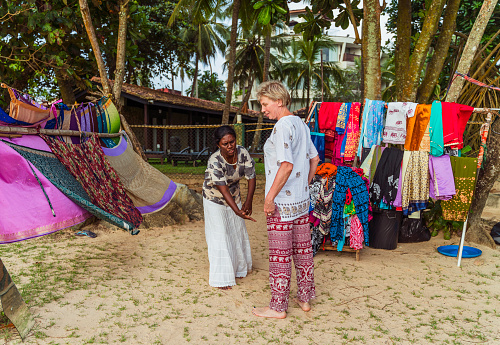 Shopping in the open-air clothing shop on a beach in Sri Lanka