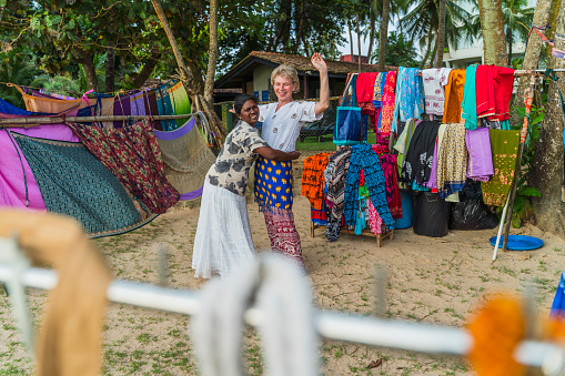 Shopping in the open-air clothing shop on a beach in Sri Lanka