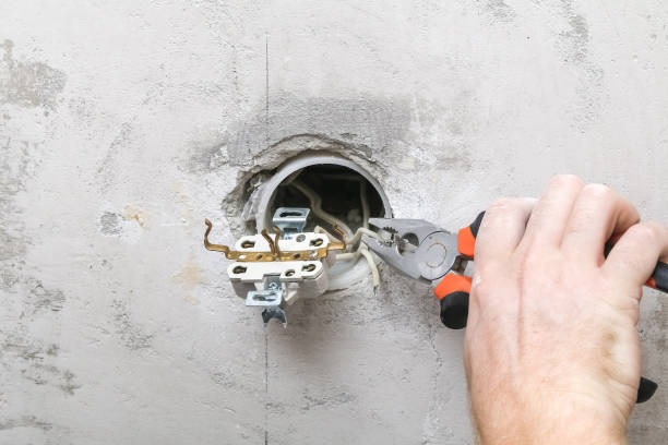 istock A man dismantles and mends electrical outlet for repairs. Power socket. 1304652301
